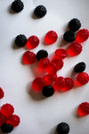 red and black candy scattered on white