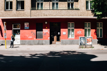 red and brown building with graffiti