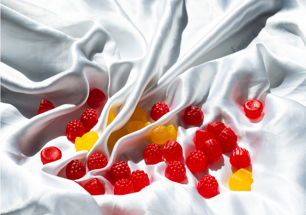 red and yellow candy in the folds of white silk