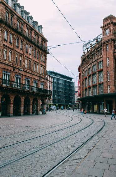 red brick buildings and tram lines in cobble streets