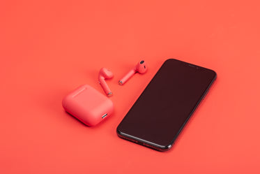 red earbuds on red surface