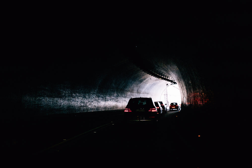 red eyes looking through darkened tunnel