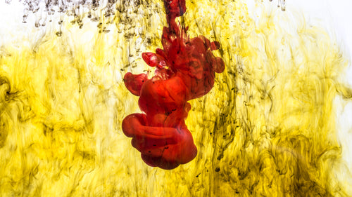 red ink drop in yellow liquid