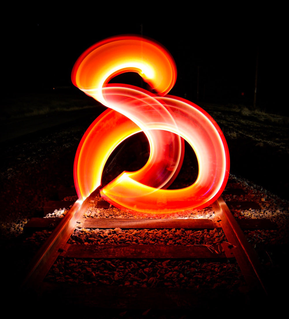 red light streaks above rail tracks