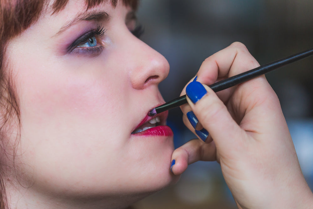 red lipstick being applied with brush
