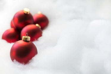 red ornaments on white snow