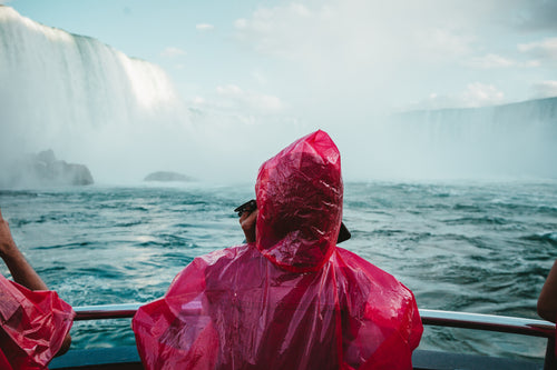 red poncho blue waterfall