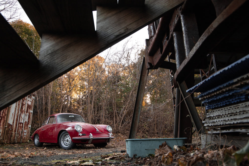 red sports car in the country on a fall day