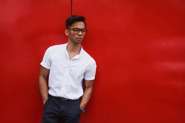 red wall behind men's summer fashion