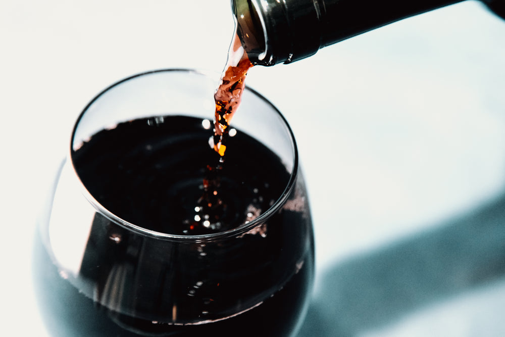 red wine pouring into a wine glass