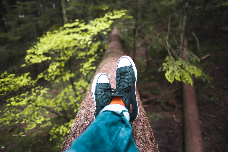 A person resting outdoors among trees