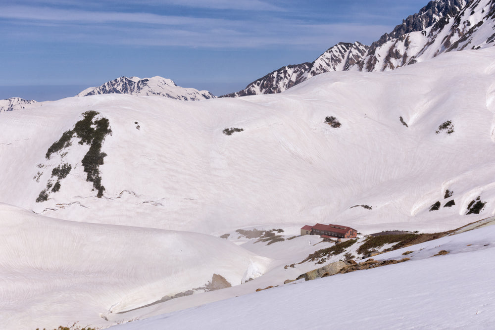 remote building between mountain ridges