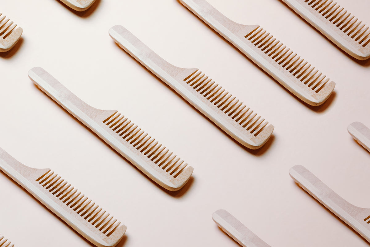 repeat pattern of combs laying on a beige surface