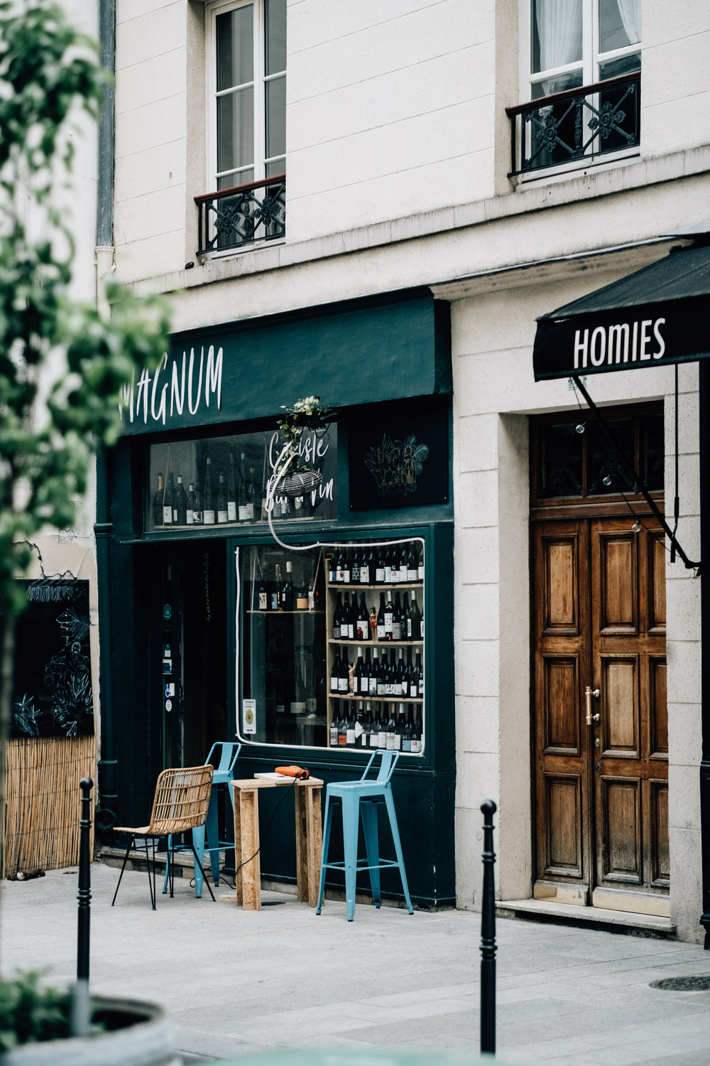 restaurant entrance with wine bottles in the window