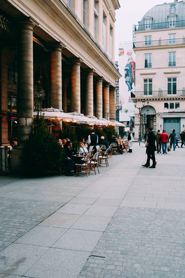 restaurant tables between columns on a piazza