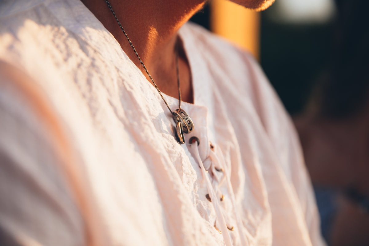Close-up of rings worn on a necklace