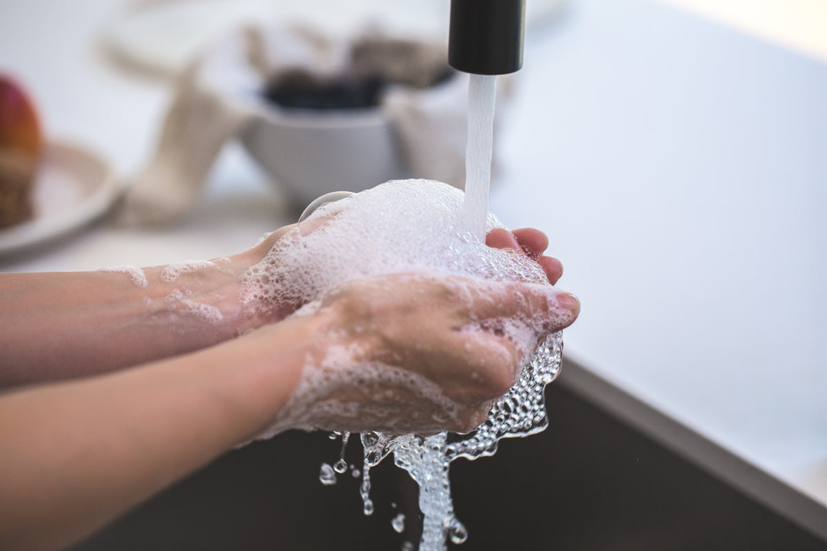 rinsing soapy hands in water