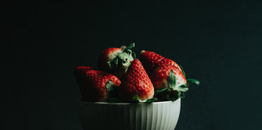 ripe red strawberries in a white bowl