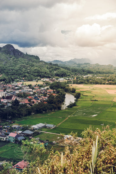 river separates community of houses from rice paddies