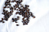 roasted coffee beans on white fabric