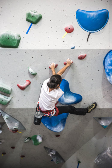 rock climber tackles a tough spot on a wall