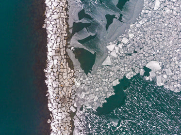 rocks on the water surrounded by ice