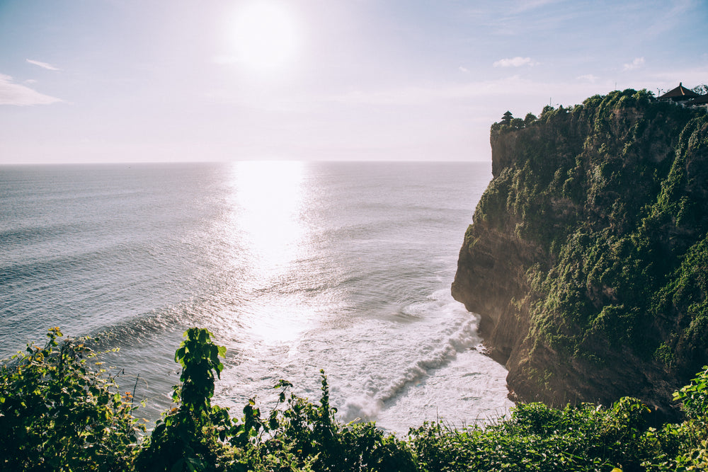 rocky cliffs of coastline covered lush jungle