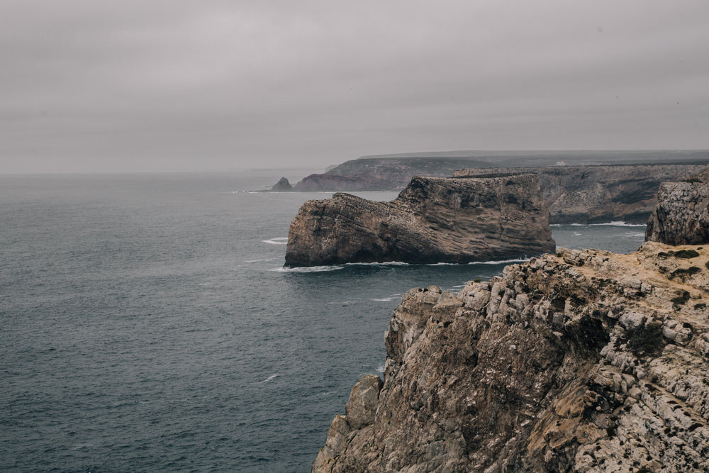 rocky cliffs roll back from the cold grey sea