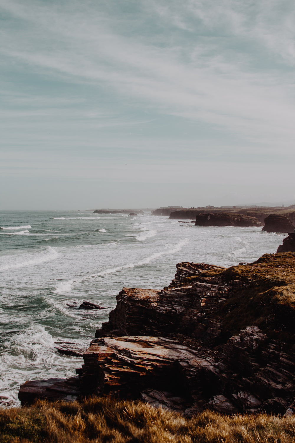 rocky coast line meets ocean waves