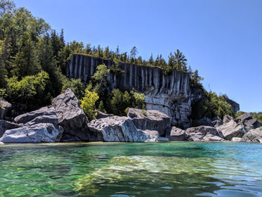 rocky escarpment by clear freshwater