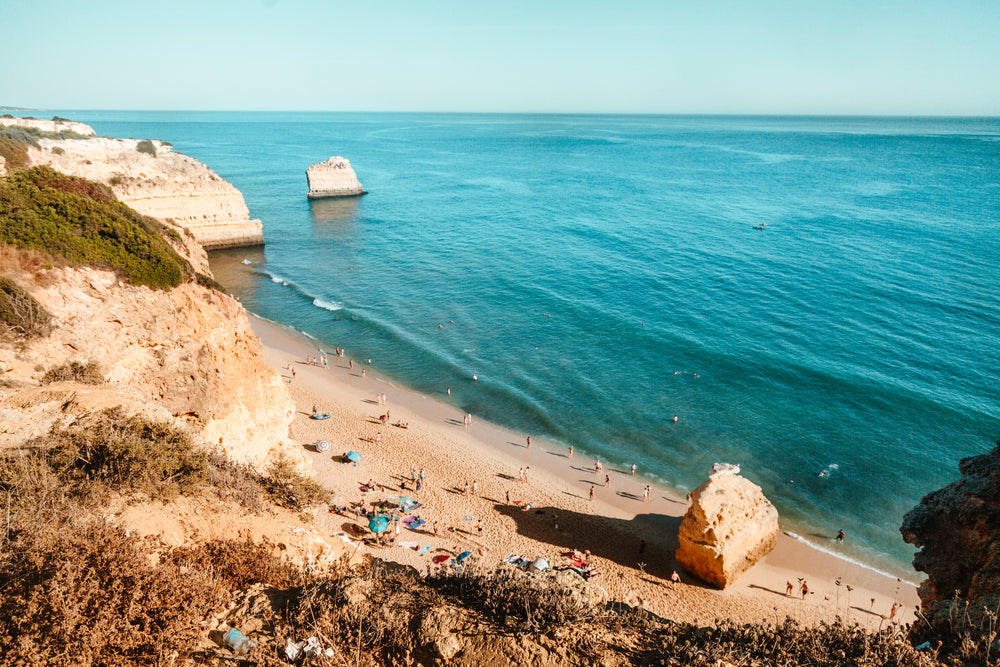 rocky outcrops creep into the water