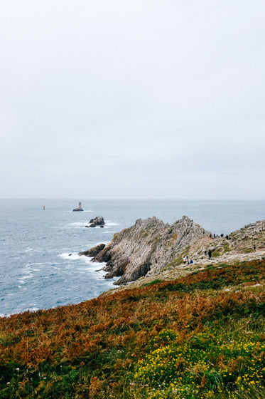 rocky shoreline reaches out to the ocean