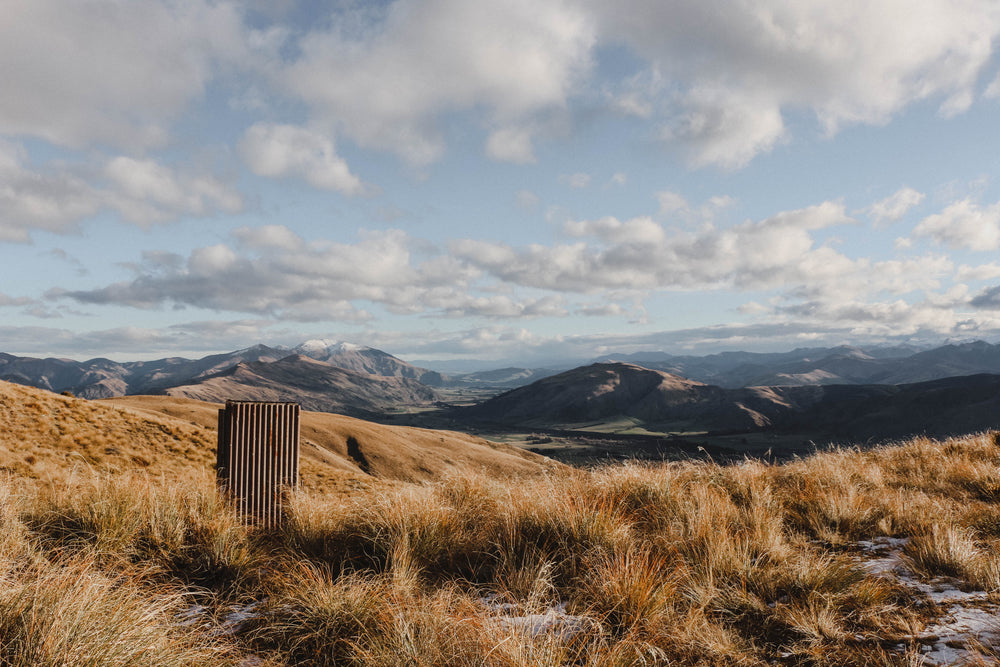 rolling foothills under cloudy blue sky