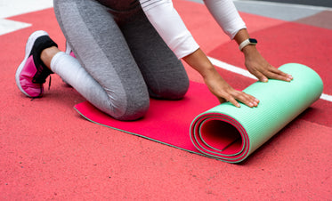 rolling out her yoga matt