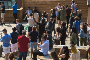 rooftop crowd cheers for the sun