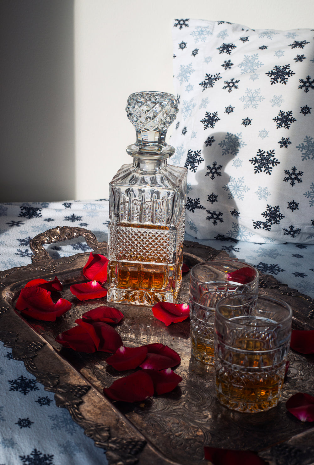 rose petals on a silver tray with matching decanter set