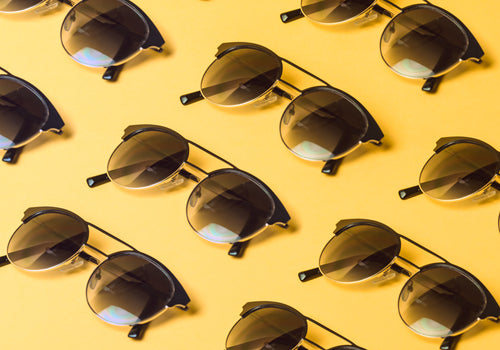 round black sunglasses repeated on yellow background