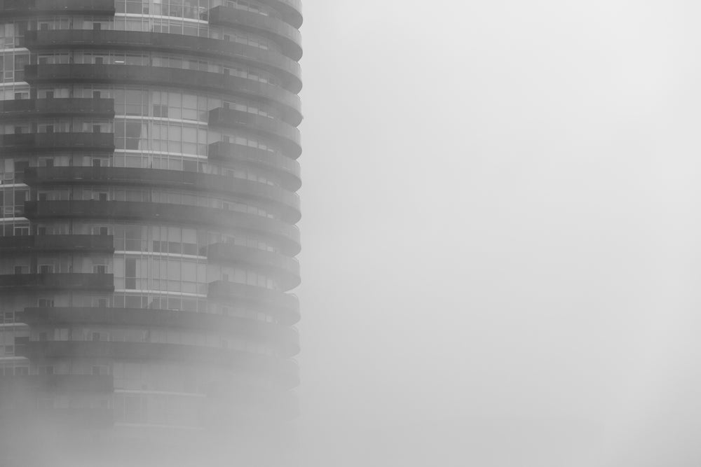 round skyscraper in fog