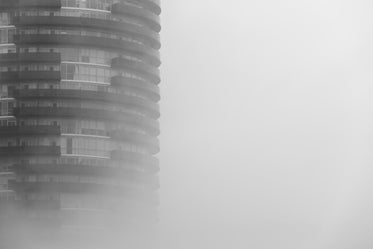 round skyscraper in fog