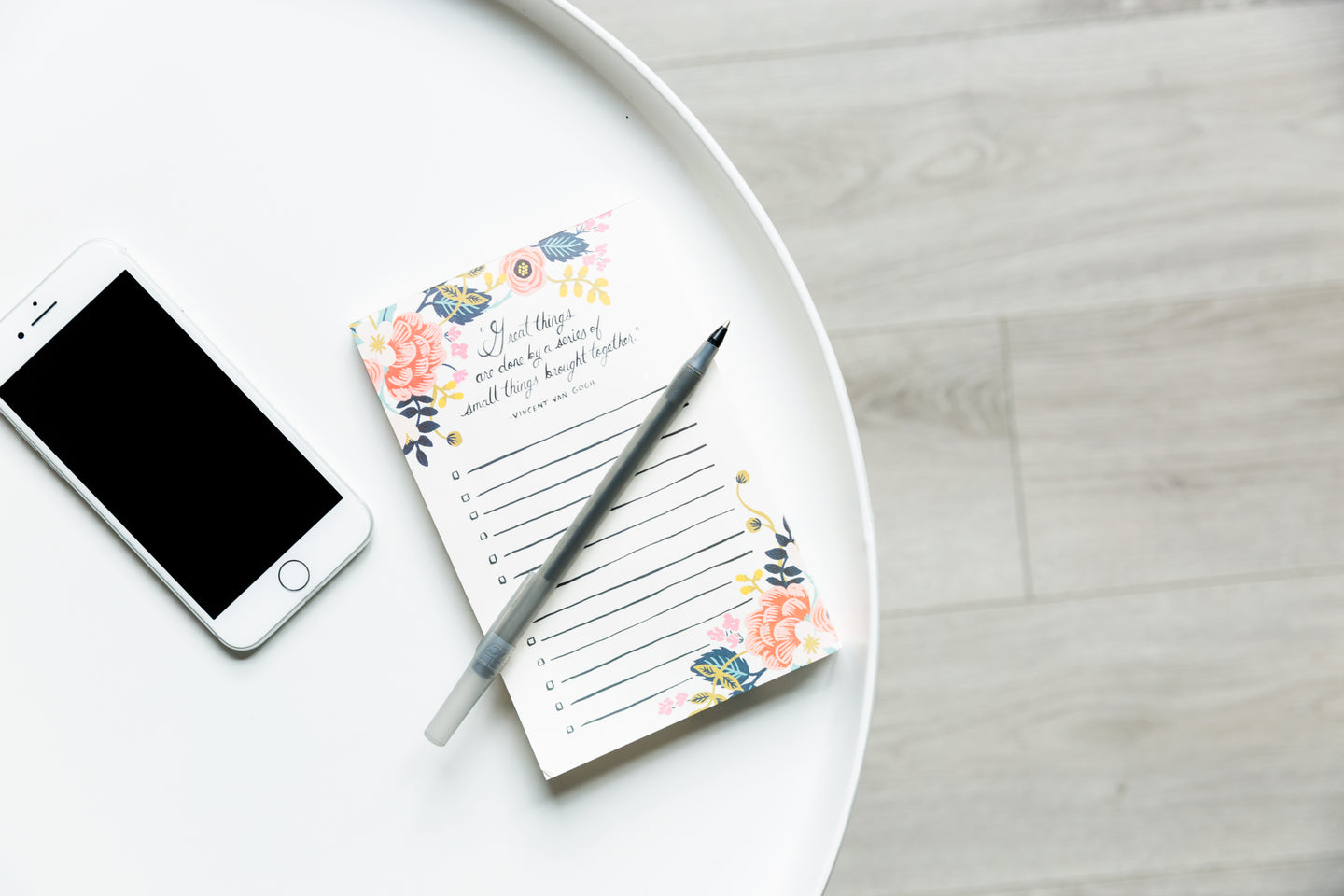 Round White Table With Phone And Notepad