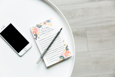 round white table with phone and notepad