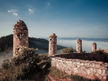 ruins covered in grass overlooking mountain tops