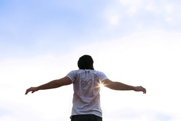 runner stretching arms in sun