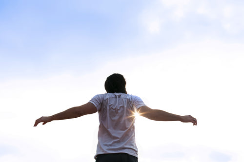 Runner Stretching Arms In Sun