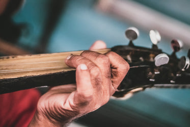 rustic hand holding guitar