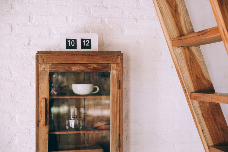 a glass cabinet with a small glass door - rustic home decor