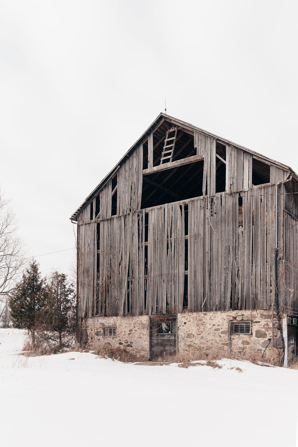 rustic old barn in the winter snow