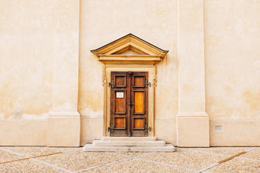 rustic wooden door by white walls