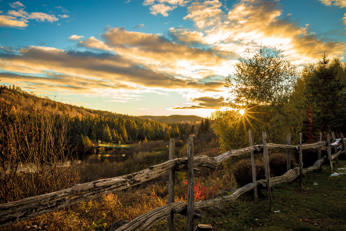 rustic wooden fence surrounding framland at sunset