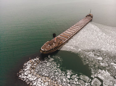 rusting freighter on icy sea
